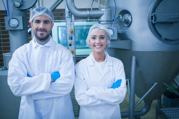 Food technicians smiling at camera in a food processing plant-2